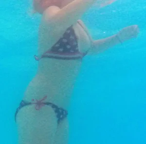 Underwater shots of a bikini teen swimming in the pool