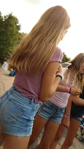 Bunch of skinny teens in shorts at the fun fair