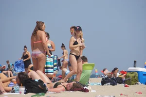 Two thick white girls in bikinis on the beach with big asses