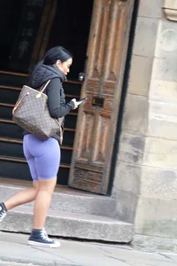 Wide hipped, juicy fronted tanned brunette pawg struts in lycra shorts