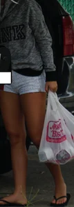 Girl next door teen neighbor bringing in groceries in short jean shorts