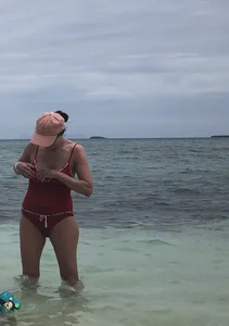 Milf at the beach in a red swimsuit with a nice body