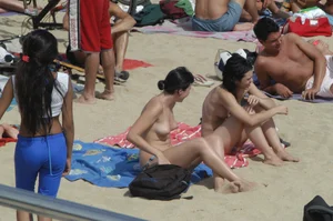 Topless girls on a beach in Barcelona