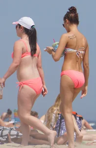 Two sexy girls in peach and pink bikinis on the beach