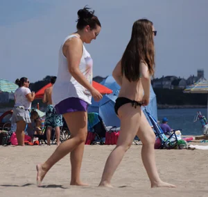 Sexy beach brunette in teal top and black bottom bikini