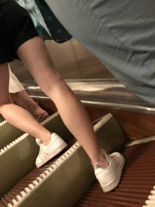 Slim legs closeup on a subway escalator creepshots