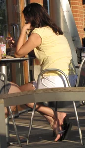 Lady in flop flops while eating showing her feet