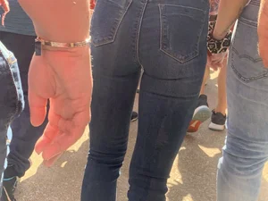 Bunch of girls in various outfits at a Cardinals baseball game