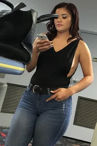 Thick brunette in tight jeans and showing some side boob