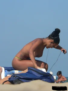 Hot ass topless beach girl with great tits lets her little brother oil up her ass in thong bikini