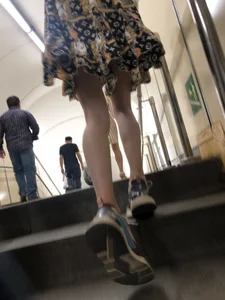 Low angle pics of a candid girl wearing a dress with long and very slim legs