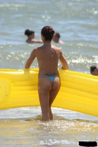 Blue thong lady in the water with a float