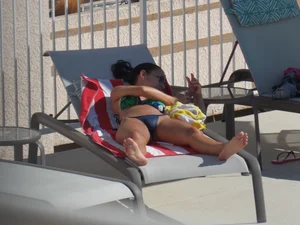 Hot milf sunbathing in a thong by pool and swimming