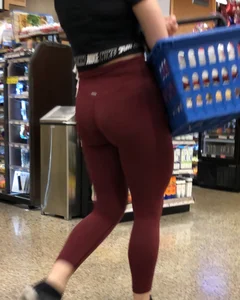 Girl with a nice ass in maroon leggings shopping
