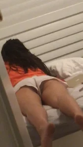 Sexy Sister in Shorts Lying on Her Stomach on Bed Home Sneaky Creepshots
