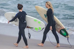 Candid girls surfing on the beach