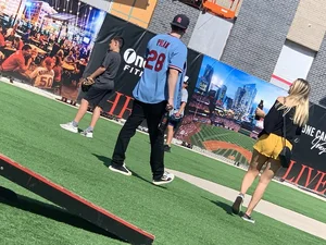 Bunch of girls in various outfits at a Cardinals baseball game
