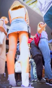 Hot blonde girl flashing her panties under the short denim skirt at the mall