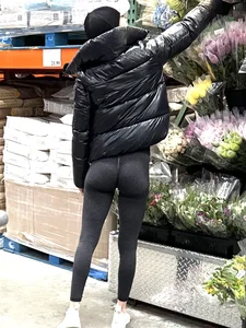 Girl in leggings with a perfect ass and slim legs picking flowers at the supermarket creepshots