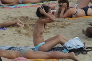 Topless girls on a beach in Barcelona