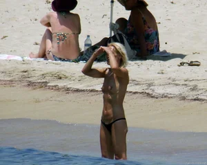 Small boobed topless milf on the beach