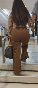Brunette in brown pants jiggly
