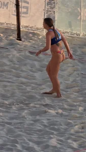 Hot athletic girl playing volleyball at the beach candid video