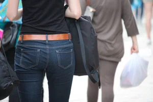 Skinny ass in tight jeans street closeup