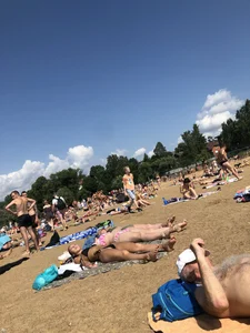 Gorgeous milf rubbing sun lotion in her skin at the beach, with a couple of her milf friends