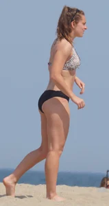 Sexy blonde girl on the beach in a bikini with nice legs, ass and stomach