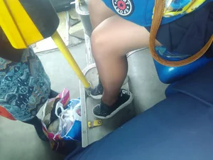 Teen legs in black pantyhose sitting in a public bus