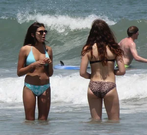 Brunette and redhead on the beach in bikinis looking sexy