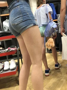 Girl with Amazing Hot Legs in Denim Shorts in a Store Candid