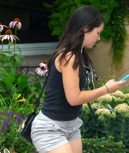 Thick brunette listening to music in shorts