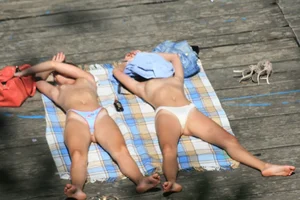 Two teens stripping and going topless to tan