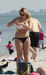 Big boobed thick blonde on the beach in a bikini