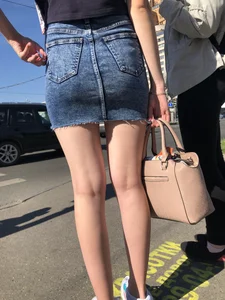 Cute Girl in a Short Denim Skirt Walking on a Street And Waiting on a Crosswalk Gallery