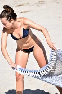 Blue bikini girl on the beach with a great ass and a little pussy lips slips