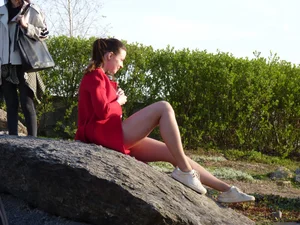 Girl with Hot Legs Lying on the Stone in the Park Candid Photo