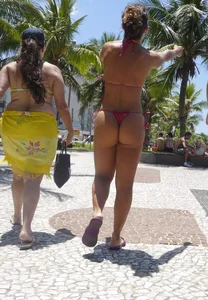 Big booty babe walking by the beach in thong