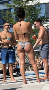 Fit brunette spotted at the pool in a cheeky bikini