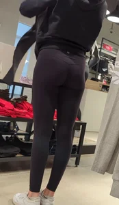 Skinny sports store employee in yoga pants