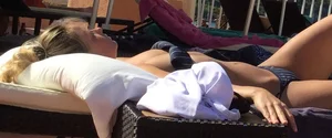 Blonde laying out in a blue bikini with a sexy body
