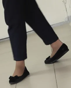 College Teen Girl's Feet in Pantyhose And Flats Closeup if the Hallway