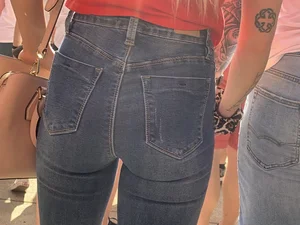 Bunch of girls in various outfits at a Cardinals baseball game