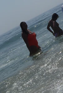 Beach girl with big boobs in an orange swimsuit