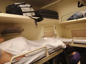 Girl Lying in Underwear under Sheets in the Train Sleeping Car