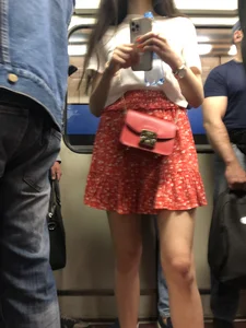 Hot candid subway chick wearing a skirt, sexy slim legs