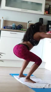 Sexy girlfriend doing yoga at home in leggings