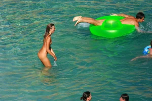 FKK Nudists playing in the water with floater